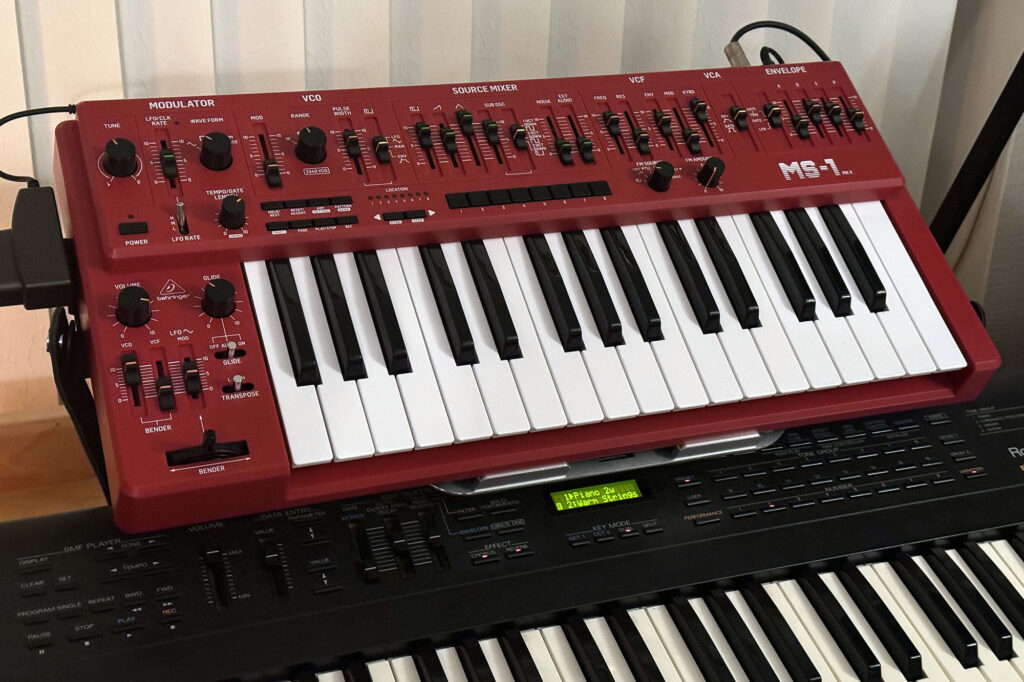 Behringer MS-1 MkII red on a desktop keyboard stand